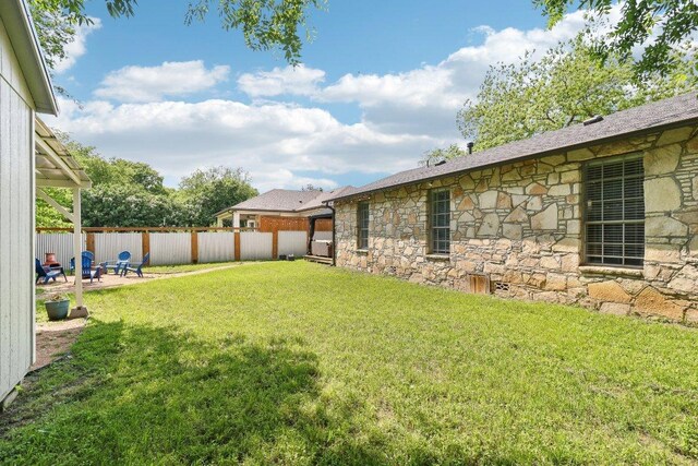 view of yard featuring fence and a patio