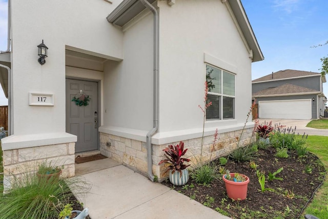 117 Thurman Holt Rd, Hutto, TX 78634 - doorway to property with stucco siding and a garage