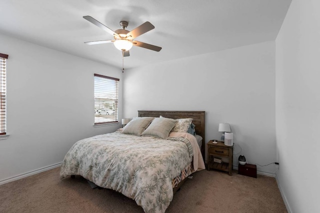 carpeted bedroom with baseboards and ceiling fan