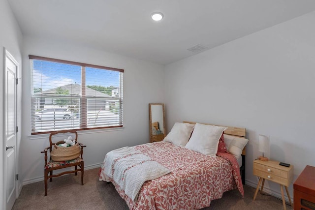carpeted bedroom featuring baseboards and visible vents