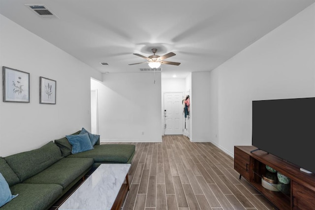 living room featuring ceiling fan, wood finished floors, and visible vents
