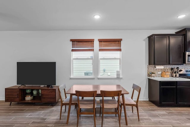 dining room with wood tiled floor, baseboards, and recessed lighting