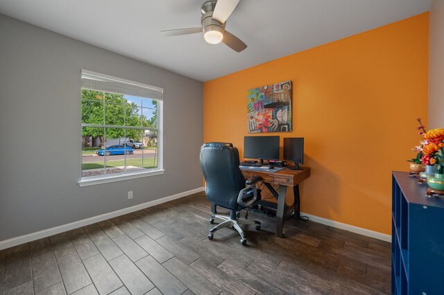 office space featuring baseboards, ceiling fan, and wood finished floors