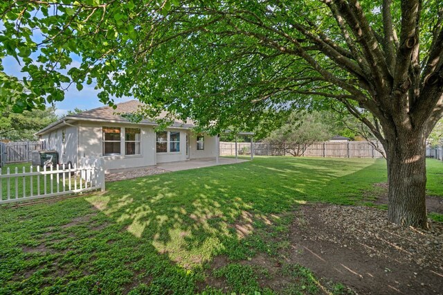view of yard featuring a patio and a fenced backyard