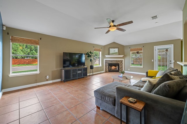 living area with baseboards, ceiling fan, visible vents, and light tile patterned floors