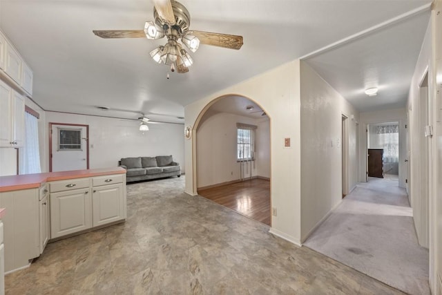 interior space with arched walkways and baseboards
