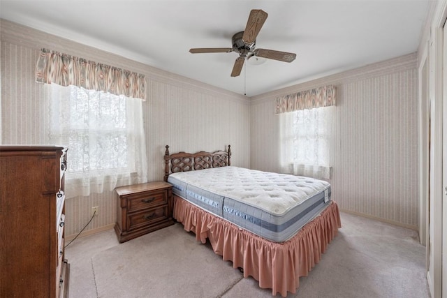 bedroom with wallpapered walls, multiple windows, baseboards, and light carpet