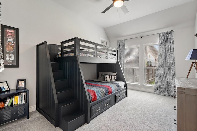 carpeted bedroom featuring a ceiling fan and vaulted ceiling