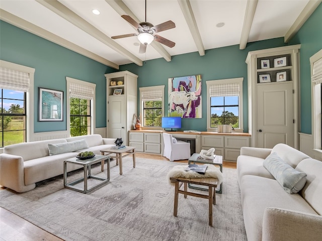 424 Hidden Creek Dr, Dripping Springs, TX 78620 - living area featuring beamed ceiling, a ceiling fan, light wood finished floors, and wainscoting