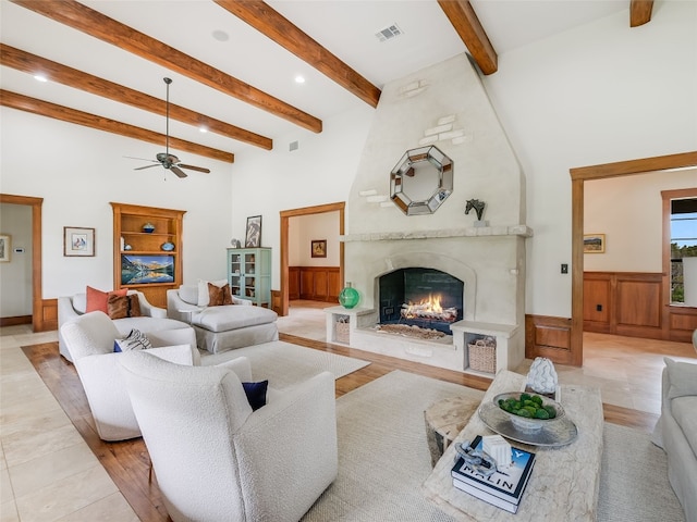 living room featuring visible vents, ceiling fan, a high ceiling, recessed lighting, and a premium fireplace