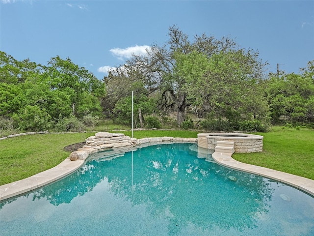 view of swimming pool featuring a lawn and a pool with connected hot tub