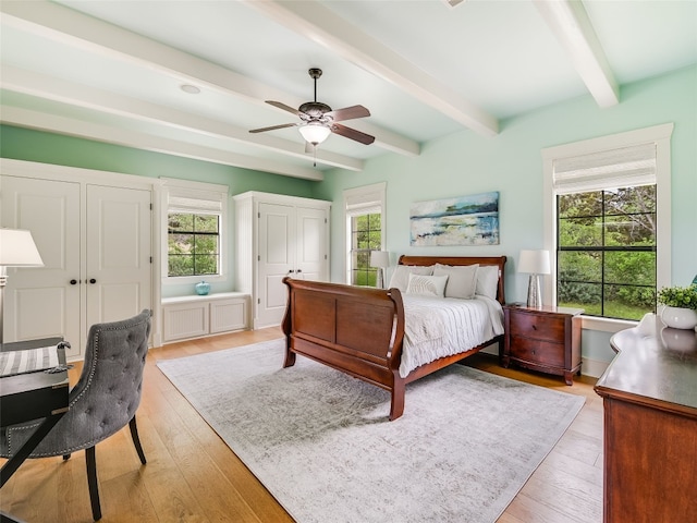 424 Hidden Creek Dr, Dripping Springs, TX 78620 - bedroom with beamed ceiling, multiple windows, light wood-type flooring, and ceiling fan