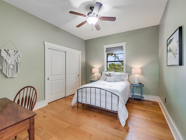 bedroom featuring baseboards, ceiling fan, a closet, and light wood-type flooring