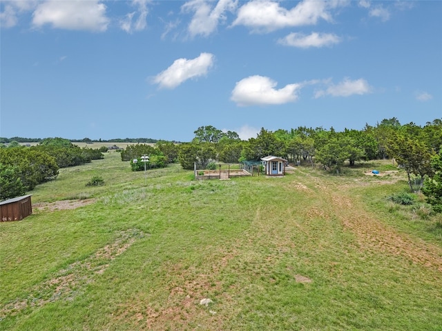 view of yard with a rural view and an outbuilding