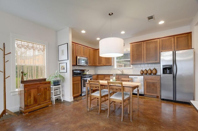 503 Allen St Unit 503A, Austin, TX 78702 - kitchen featuring appliances with stainless steel finishes, brown cabinetry, recessed lighting, finished concrete floors, and tasteful backsplash
