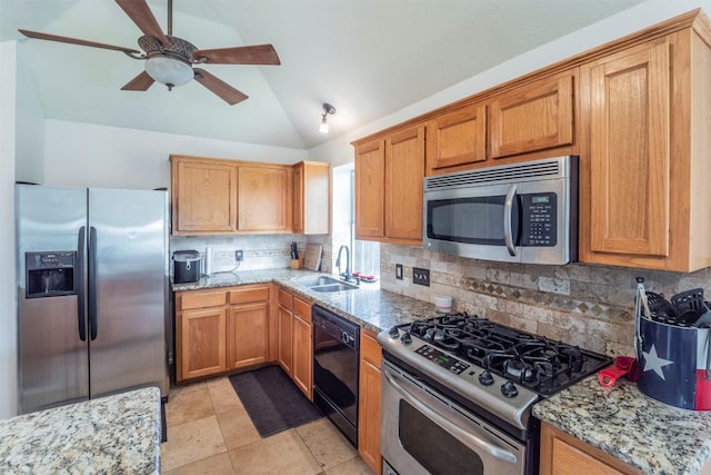 kitchen with a ceiling fan, tasteful backsplash, a sink, lofted ceiling, and stainless steel appliances