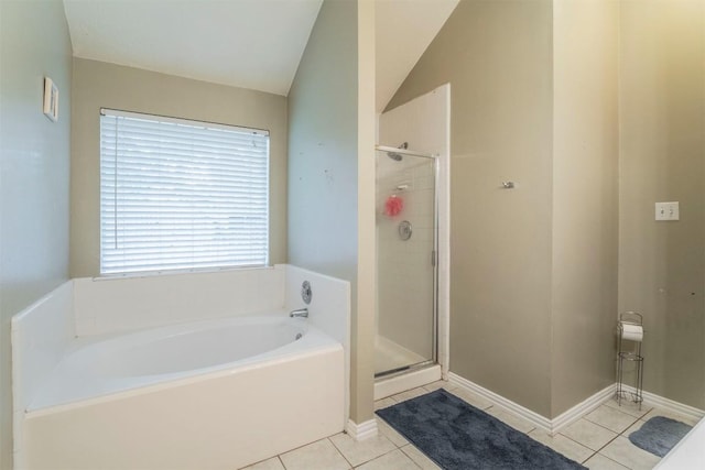 bathroom with a shower stall, tile patterned flooring, and a garden tub
