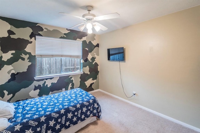 carpeted bedroom with a ceiling fan and baseboards