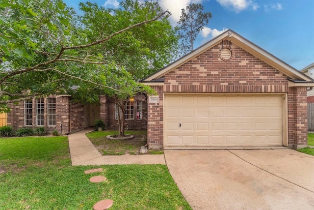 view of front of house with a garage, concrete driveway, a front yard, and brick siding