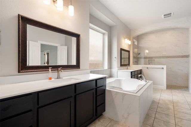 103 Lockhart Loop, Georgetown, TX 78628 - full bath with a marble finish shower, a bath, marble finish flooring, and vanity