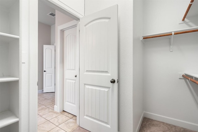 103 Lockhart Loop, Georgetown, TX 78628 - walk in closet featuring light tile patterned flooring and attic access