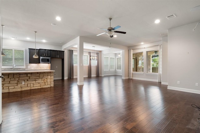 103 Lockhart Loop, Georgetown, TX 78628 - unfurnished living room featuring a ceiling fan, recessed lighting, and dark wood-type flooring