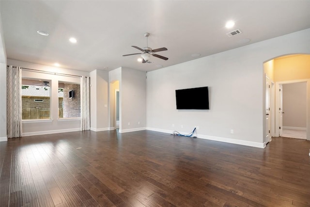 103 Lockhart Loop, Georgetown, TX 78628 - unfurnished living room featuring arched walkways, a ceiling fan, dark wood-style flooring, and recessed lighting