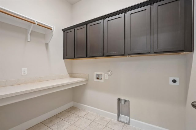 103 Lockhart Loop, Georgetown, TX 78628 - washroom featuring electric dryer hookup, hookup for a washing machine, cabinet space, light tile patterned flooring, and hookup for a gas dryer