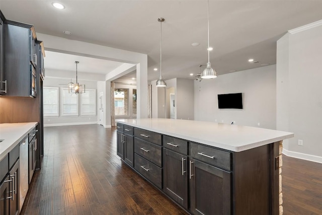 103 Lockhart Loop, Georgetown, TX 78628 - kitchen featuring dark wood-style floors, open floor plan, light countertops, hanging light fixtures, and recessed lighting