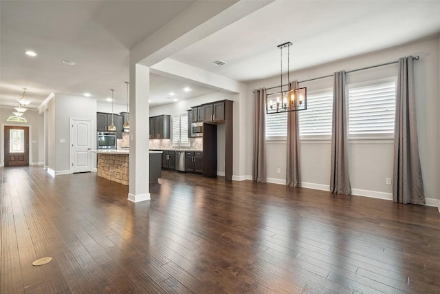 103 Lockhart Loop, Georgetown, TX 78628 - unfurnished living room with a chandelier, recessed lighting, and dark wood-style flooring