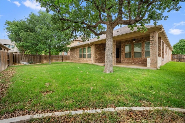 103 Lockhart Loop, Georgetown, TX 78628 - rear view of house featuring ceiling fan, brick siding, a fenced backyard, and a patio area