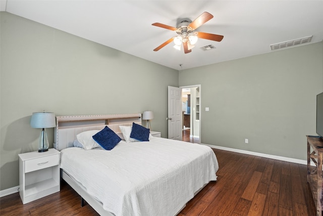 bedroom with baseboards, wood finished floors, and visible vents