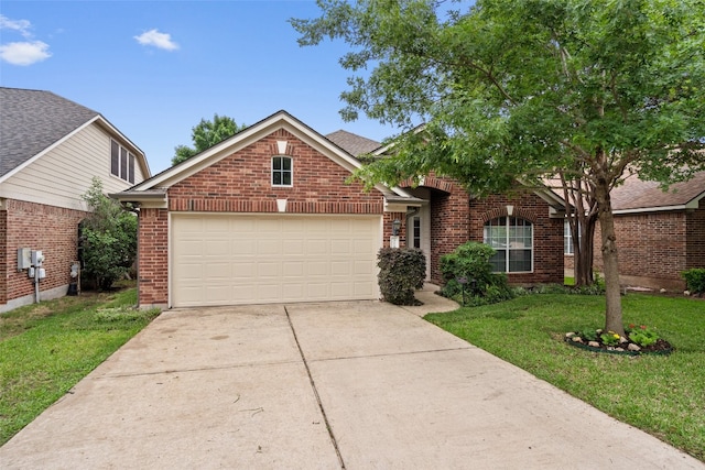 traditional-style house with brick siding, a garage, driveway, and a front lawn