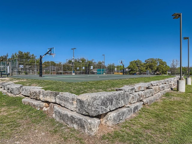 view of community featuring community basketball court and fence
