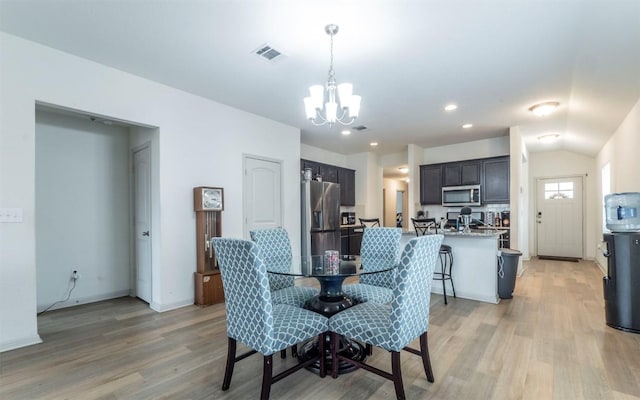 dining space featuring visible vents, baseboards, light wood finished floors, a notable chandelier, and recessed lighting