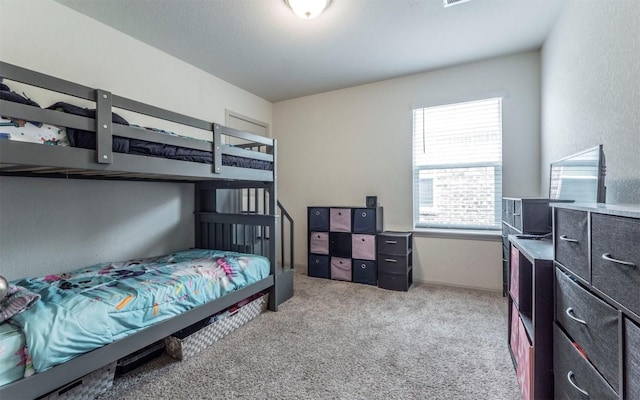 bedroom featuring light carpet