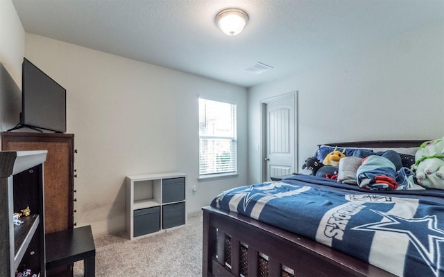bedroom with light carpet and visible vents