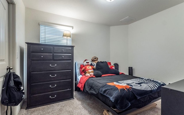 bedroom with light carpet and visible vents