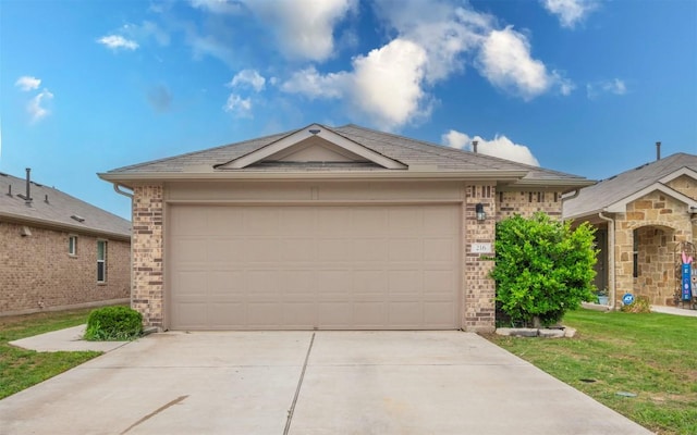 ranch-style home with brick siding, an attached garage, driveway, and a front lawn