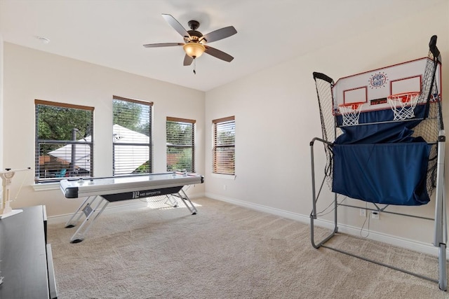 game room with carpet floors, a ceiling fan, and baseboards