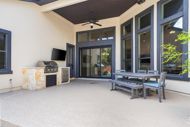 view of patio featuring outdoor dining area, a ceiling fan, exterior kitchen, and a grill