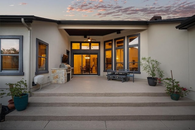 exterior entry at dusk with stucco siding