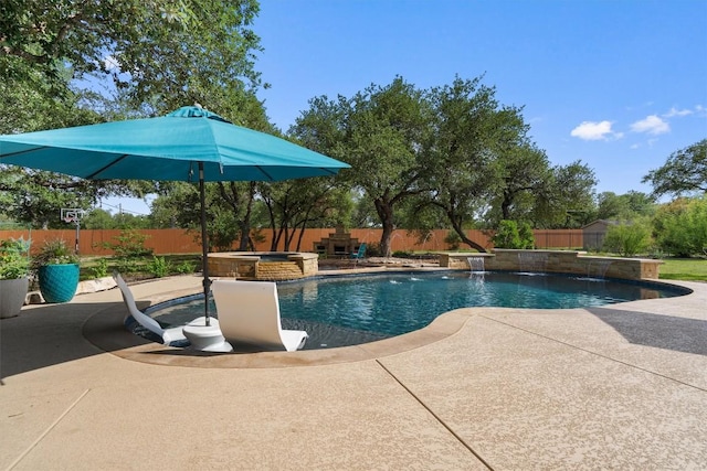 view of pool with a fenced backyard, a patio, and a pool with connected hot tub