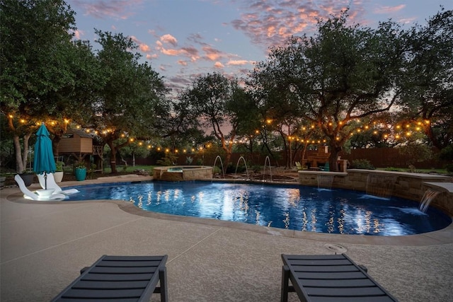 view of pool featuring a patio and a pool with connected hot tub