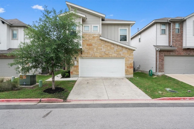 907 Totis Rd, Austin, TX 78748 - view of front of house with stone siding, an attached garage, board and batten siding, a front lawn, and concrete driveway