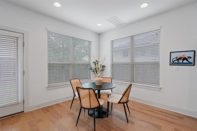 dining area with visible vents, light wood-style floors, and a healthy amount of sunlight