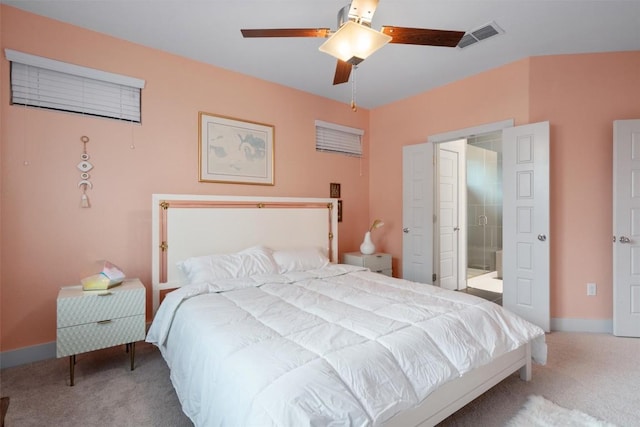 bedroom featuring carpet floors, visible vents, baseboards, a ceiling fan, and ensuite bath