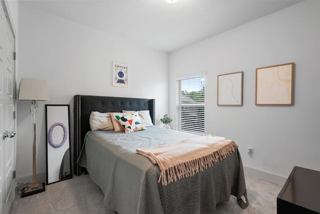 bedroom with carpet floors and baseboards