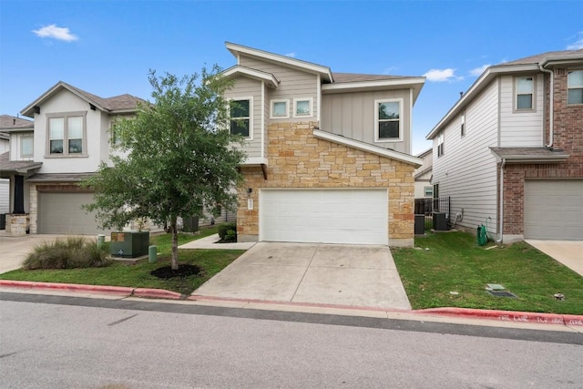 907 Totis Rd, Austin, TX 78748 - view of front of home with board and batten siding, stone siding, a garage, concrete driveway, and a front yard