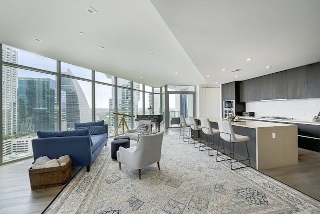 living area featuring a wall of windows and a view of city